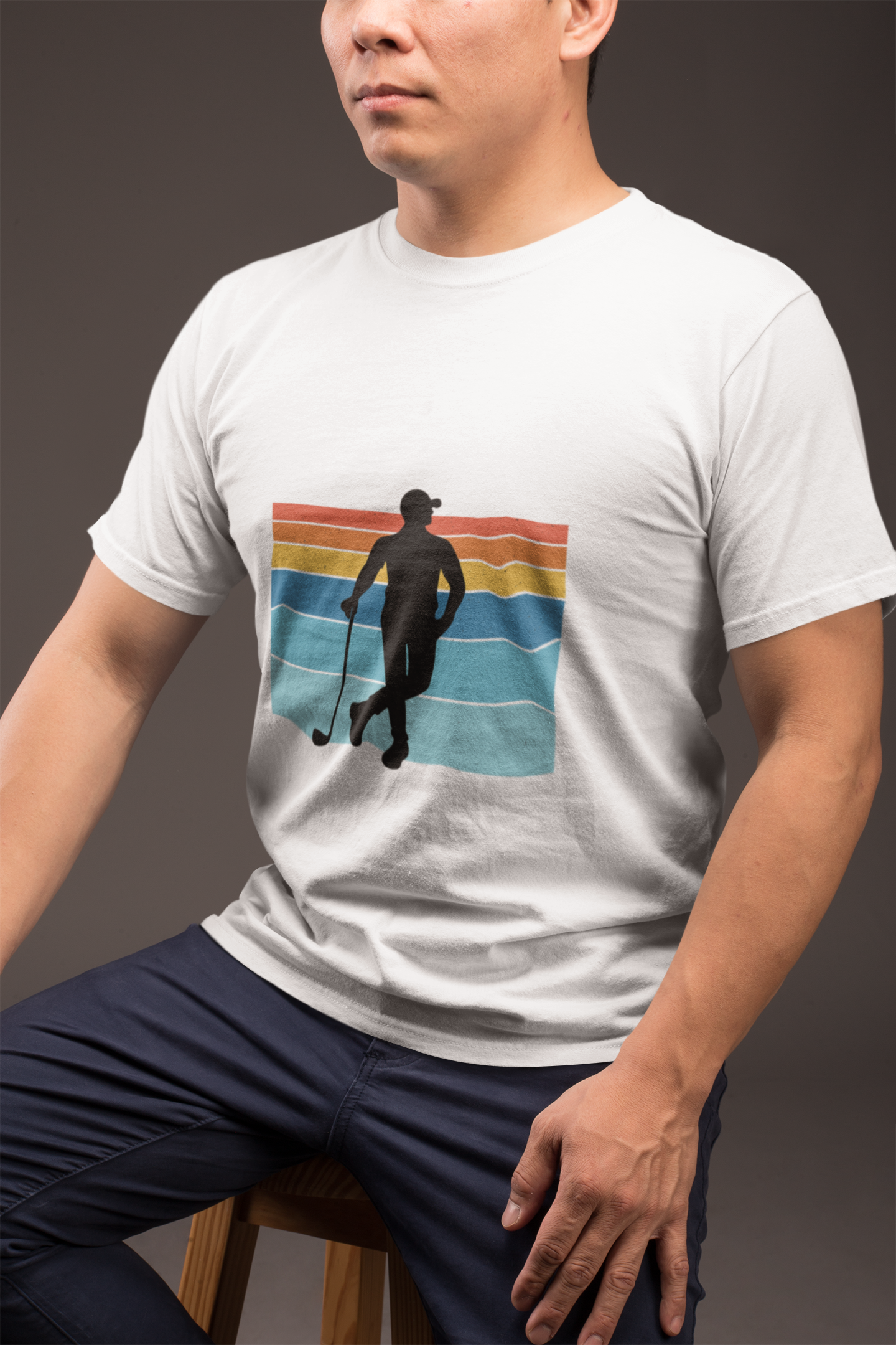 crew-neck-tee-mockup-of-a-guy-in-blue-trousers-sitting-on-a-stool-against-a-dark-gray-wall-21235_60adf728-5b99-4add-a613-2d1de203e31f.png